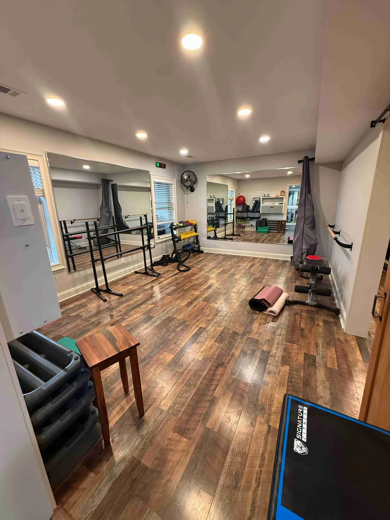 Private studio space with wood flooring and natural light