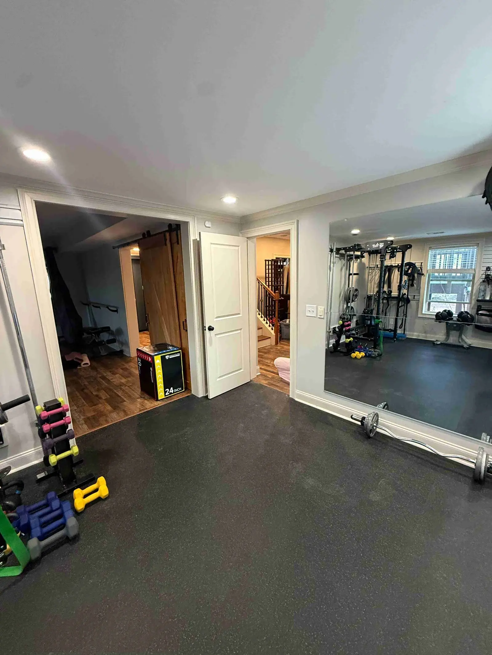 Spacious workout floor with dumbbell rack and mirrors
